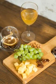 Snacks for wine: grapes, cheese, nuts Stock Photos
