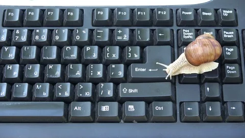 Snail on computer keyboard  crawling on ENTER button 스톡 동영상 76507359