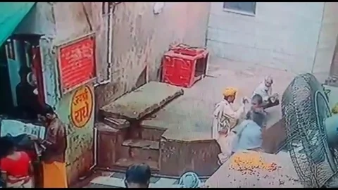 Snake charmer chases monkey after it snatches his cobra Stock Footage 106298617