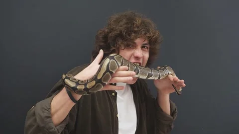 A snake crawling on a man. A young man is undergoing a course of overcoming his Video stock 157636611