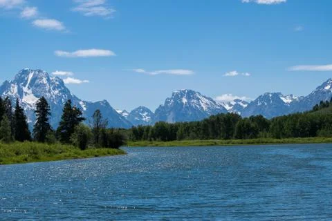 SNAKE RIVER WINDS BENEATH THE SNOW CAPPED GRAND TETONS Stock Photos