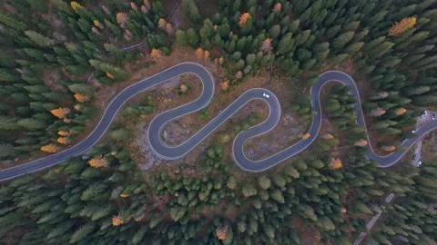 Snake Road twists through rugged peaks, Dolomites, seen from above Stock Footage 321600541