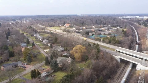 Snaking Freight Train Over Hazy Suburban Midwest USA Neighborhood Aerial, 4k Stock Footage 124904007