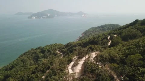 Snaky pathway with bikers on a hill Stock Footage 299949456