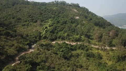 Snaky pathway with bikers on a hill Stock Footage 299949474