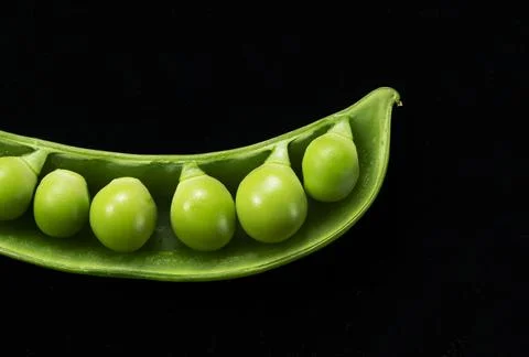 Snap peas placed on a black background Stock Photos