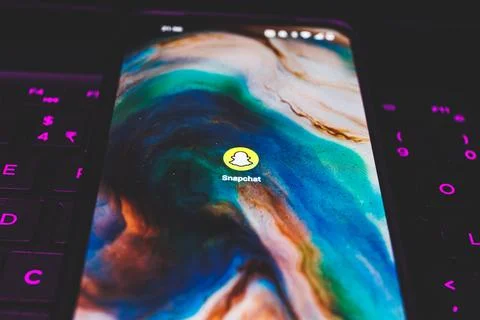 Snapchat app on smartphone screen. Close up shot of Snapchat app Stock Photos