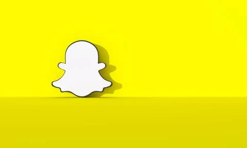 Snapchat logo on yellow wall background with hard shadow and space for text a Illustrazione stock