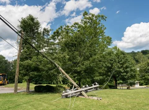 Snapped and downed power post and line after storm Stock Photos