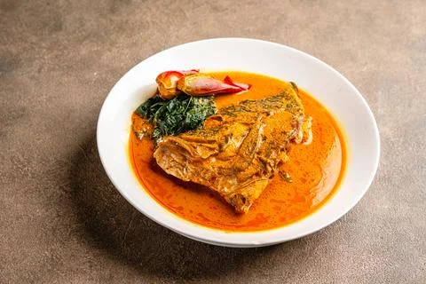 Snapper curry fish head or gulai kepala ikan kakap Stock Photos