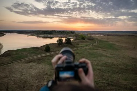 Snapping hands camera beautiful landscape at sunrise Stock Photos