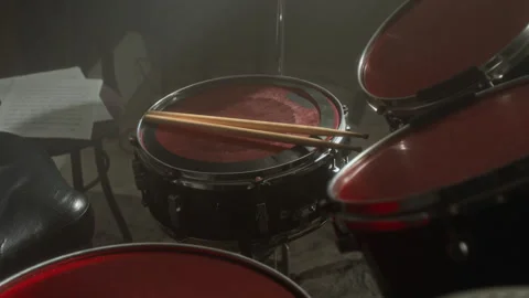 Snare Drum with Drumsticks Resting in Dark Smoky Music Studio Stock Footage 338394287