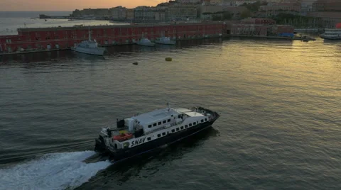 SNAV ferry pulls into Naples, Italy harbor at sunset - 4K UHD 0240 Stock Footage 50056467