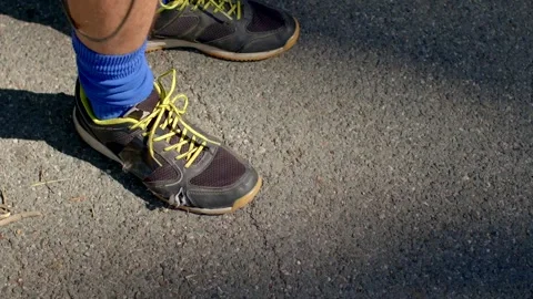 Sneaker pause before run, closeup of runner resting and preparing Stock Footage 320956567