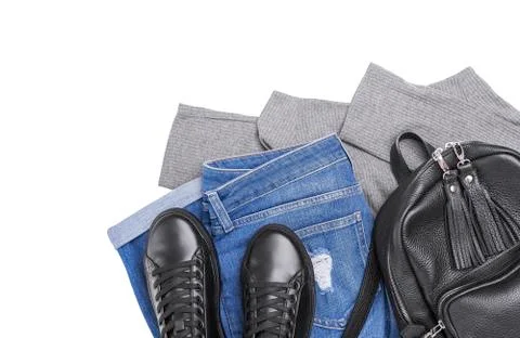 Sneakers backpack jeans and a light sweater. Stock Photos