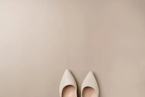 Sneakers on beige background. Space for text Stock Photos