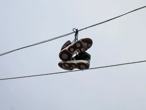 Sneakers hanging on a cable Stock Photos