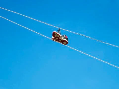 Sneakers hanging on a cable Stock Photos
