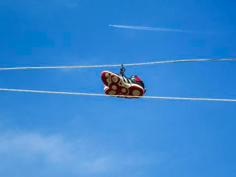 Sneakers hanging on a cable Stock Photos