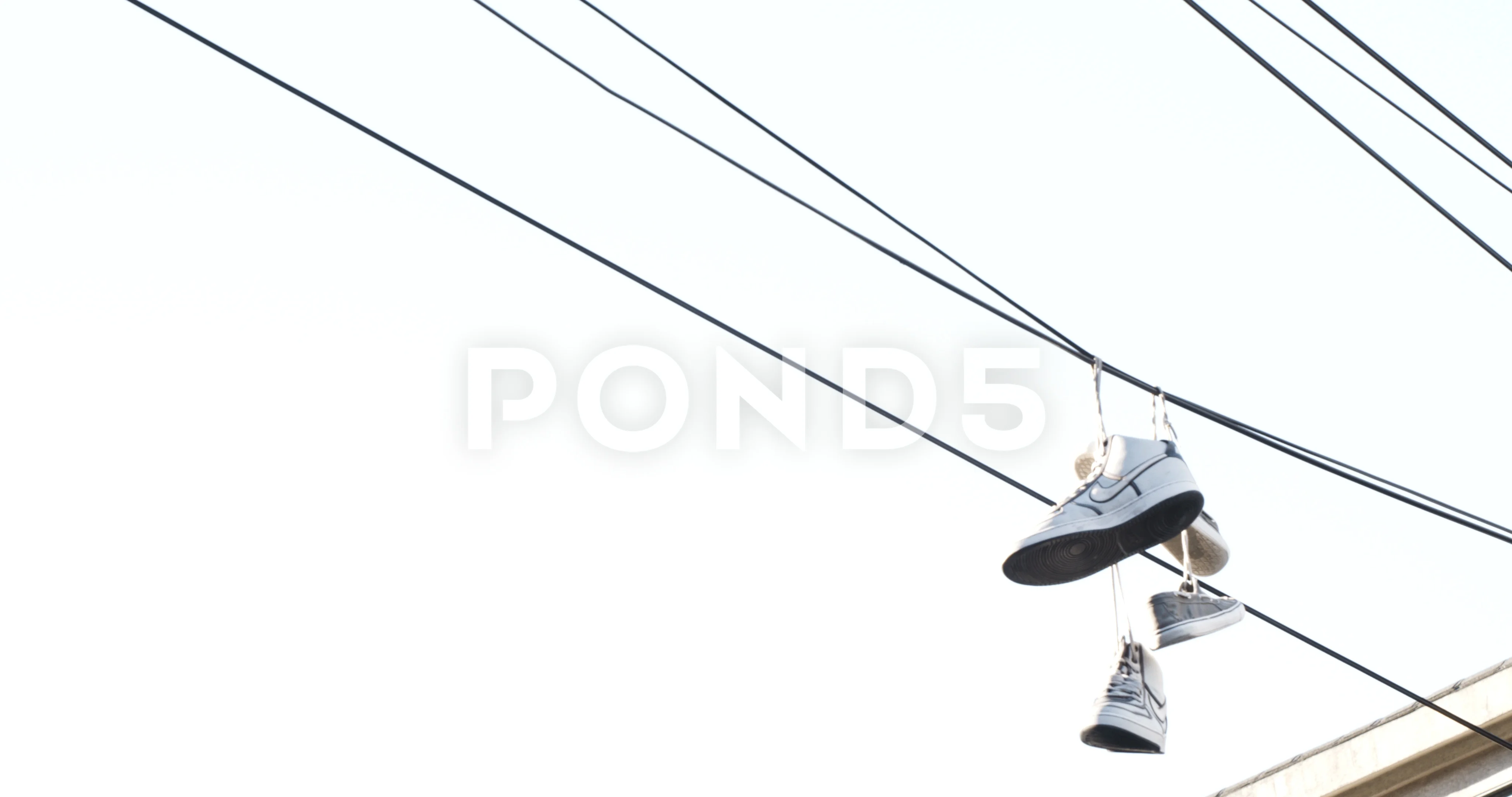 Sneakers Hanging On Electric Wires Against A Background Of Blue Sky And  White Clouds. Stock Photo, Picture and Royalty Free Image. Image 177237008.
