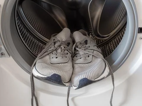 Sneakers inside the washing machine Stock Photos