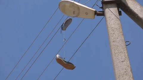 Sneakers lamppost post wire shoes Stock Footage 93735580