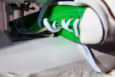 Sneakers on the sewing machine Stock Photos