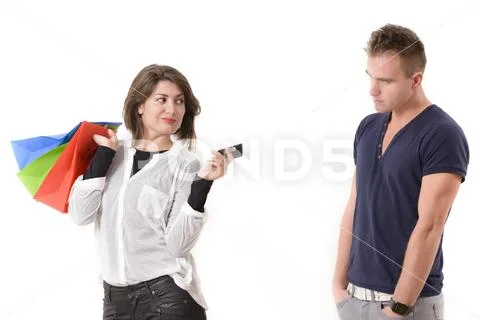 Sneaky shopaholic woman holding credit card and shopping bags Stock Photos