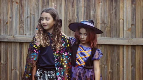 Sneaky Witch Making Fun of Friend on Halloween Mid Shot Stock Footage 162113193