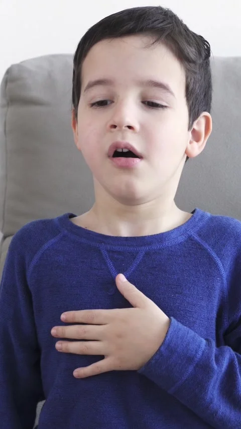 Sneezing boy suffering from flu or allergy Vídeos de archivo 335240991