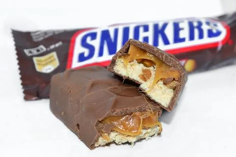 Snickers bars lie on a white background Stock Photos