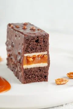 Snickers cake. Dessert based on chocolate biscuit, creamy mousse with caramel Stock Photos