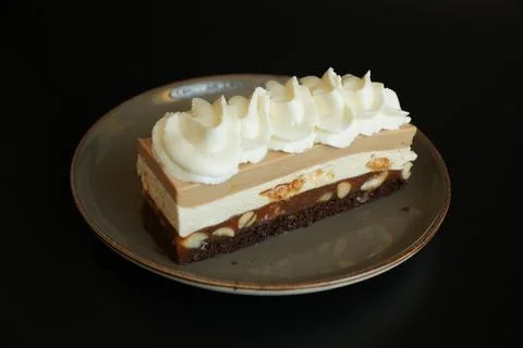 Snickers Style Cake Slice Isolated on Black Background Stock Photos