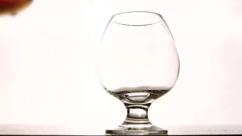 The snifter is being fulfilled with expensive cognac in the luxury restaurant Stock Footage 82736270