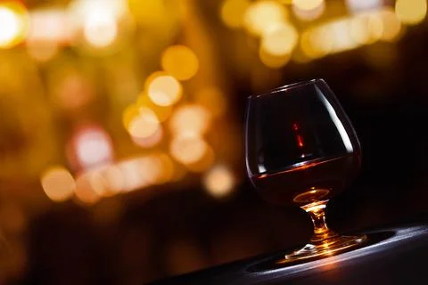 Snifter with brandy on black table in bar Stock Photos