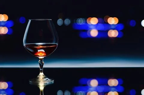 Snifter with brandy on dark background Stock Photos