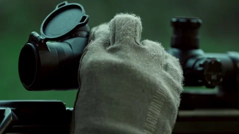 Sniper adjusts the scope. Special operation. Shot at the target. . Video stock 107484828