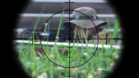 The sniper is aiming to kill the enemy through the scope Stock Footage 243194738