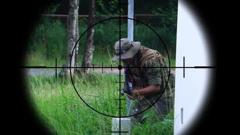 The sniper is aiming to kill the enemy through the scope Stock Footage 243199672