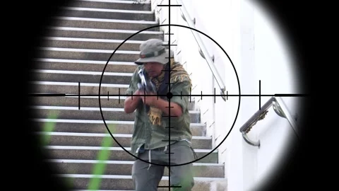 The sniper is aiming to kill the enemy through the scope Stock Footage 243199717