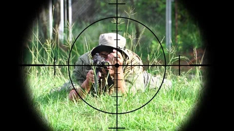 The sniper is aiming to kill the enemy through the scope Video stock 243200923