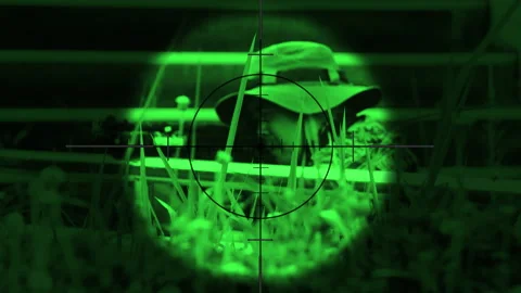 The sniper is aiming to kill the enemy through the scope nightvision Video stock 247705130