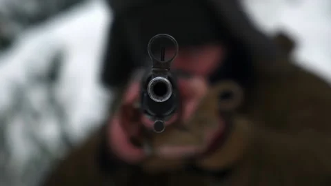 The sniper aims directly at the camera with a weapon Stock Footage 221094060