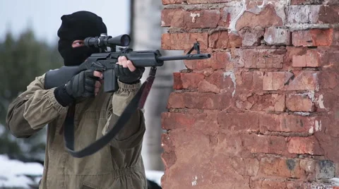 Sniper comes out and makes a shot and hiding behind a wall Stock Footage 44786531