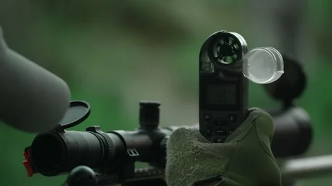 Sniper determines the speed and direction of the wind. Stock-Footage 107323549