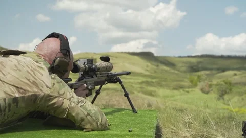 The sniper look through the optical sight of the rifle and fire a shot Stock-Footage 246190272
