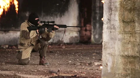 Sniper makes 3 shots in a burning building Stock Footage 44783810