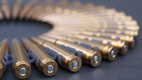 Sniper or machine gun ammo belts on a production line. Deadly ammunition. 動画素材 104429132