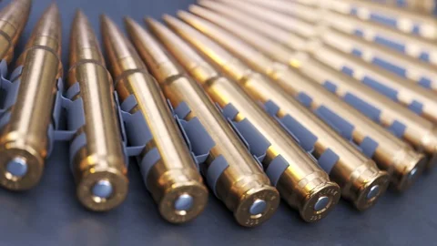 Sniper or machine gun ammo belts on a production line. Deadly ammunition. 動画素材 104429250