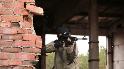 Sniper out of hiding and make a shot Stock Footage 44783335